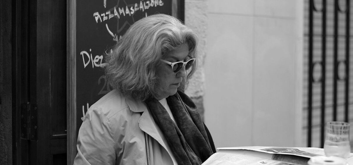 A reader catching up on the news over coffee